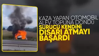 Alev topuna dönen otomobilden canını zor kurtardı